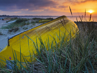 Upturned Boat Among The Sand Dunes At Mudeford Spit, Dorset, England by Adam Burton Pricing Limited Edition Print image