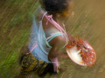 Woman Selling Fish At A Station For The Train Between Manakara And Fianarantsoa, Madagascar by Inaki Relanzon Pricing Limited Edition Print image