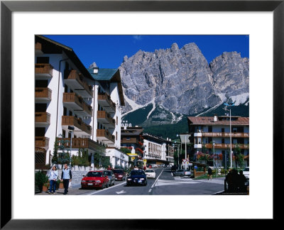 Apartment Buildings With Cliffs Of Cristallo Group Behind, Cortina, Veneto, Italy by Grant Dixon Pricing Limited Edition Print image