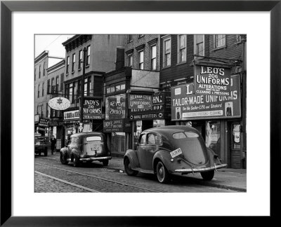 Cars Parked In Front Of Four Navy Uniform Stores On Sand Street by Andreas Feininger Pricing Limited Edition Print image