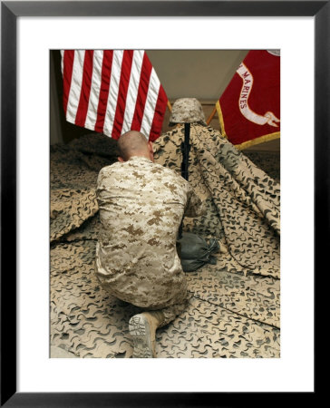 A Marine Kneels Before The Rifle, Boots And Identification Tags During A Memorial Service by Stocktrek Images Pricing Limited Edition Print image