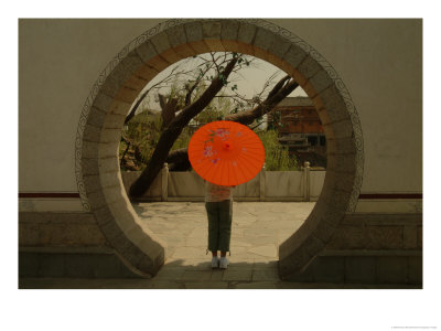 Rear View Of A Girl Standing In An Arch With A Red Umbrella by Richard Nowitz Pricing Limited Edition Print image