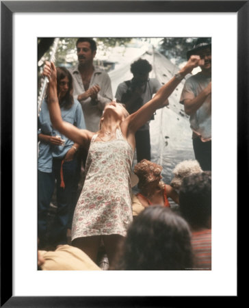 Young Woman With Flute Ecstatically Raising Her Arms, Amid Crowd At Woodstock Music Festival by Bill Eppridge Pricing Limited Edition Print image