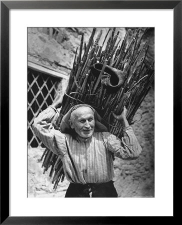 View Of A Man Carrying A Big Bundle Of Sticks From A Story Concerning Italy by Thomas D. Mcavoy Pricing Limited Edition Print image