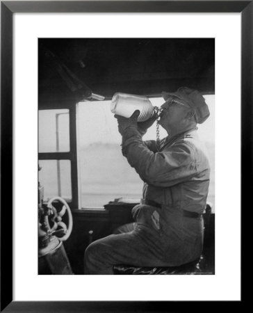 Engineer In The 20Th Century Limited Drinking Water From Glass Jug He Kept Underneath His Stool by Alfred Eisenstaedt Pricing Limited Edition Print image