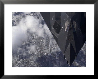 An F-117A Nighthawk Flies High Over The Mountains Above New Mexico by Stocktrek Images Pricing Limited Edition Print image