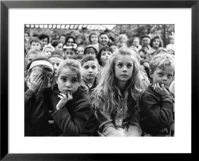 Audience Of Children Sitting Very Still, With Rapt Expressions, Watching Puppet Show At Tuileries by Alfred Eisenstaedt Pricing Limited Edition Print image