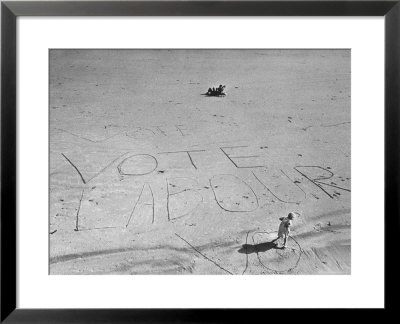 Girl Standing By The Words Vote Labour Written In The Sand by Cornell Capa Pricing Limited Edition Print image
