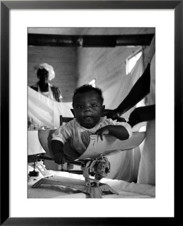 Nurse-Midwife Maude Callen Weighing Baby On Scale by W. Eugene Smith Pricing Limited Edition Print image