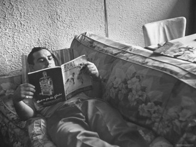 Baseball Player Yogi Berra Relaxing At Home With His Favorite Reading Matter by George Silk Pricing Limited Edition Print image