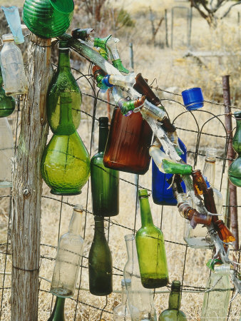 Multi-Cloured Bottles On Wire & Wooden Fence by Georgia Glynn-Smith Pricing Limited Edition Print image