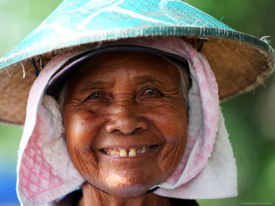 Portrait Of An Elderly Masseur Woman Wearing A Conical Sunhat by Andrew Brownbill Pricing Limited Edition Print image