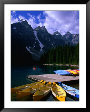 Canoeing On Moraine Lake, Banff National Park, Alberta, Canada by Lawrence Worcester Pricing Limited Edition Print image