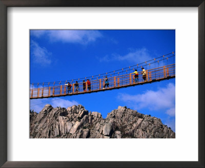 Hikers Crossing Steel Suspension Bridge Over Crevasse, Wolchulsan National Park, South Korea by Martin Moos Pricing Limited Edition Print image