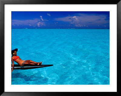 Woman Basking In The Sun On An Outrigger Boat In An Island Lagoon, Huahine Iti, French Polynesia by Jean-Bernard Carillet Pricing Limited Edition Print image