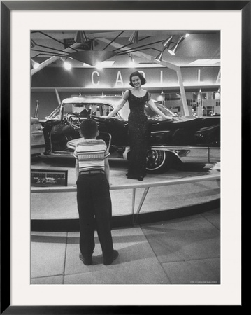 Model Posing Beside Cadillac Eldorado Captures Attention Of Young Boy At National Automobile Show by Walter Sanders Pricing Limited Edition Print image