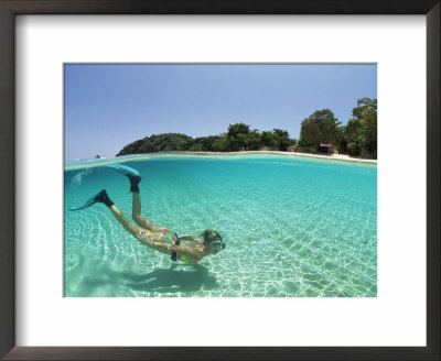 Split Level Shot Of Snorkler Swimming, Malaysia by Jurgen Freund Pricing Limited Edition Print image