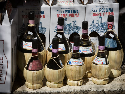 Bottles Of Chianti Displayed Outside Of A San Gimignano Shop, Italy by Robert Eighmie Pricing Limited Edition Print image