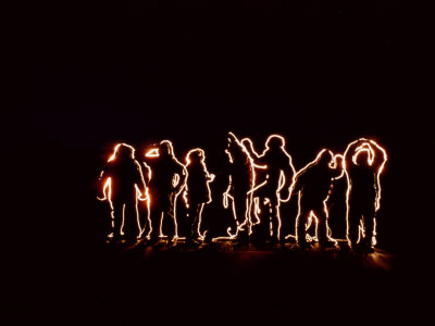 Light Of A Flashlight Outlines A Group Of People by Tom Murphy Pricing Limited Edition Print image