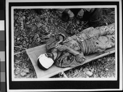 Blindfold And Bandaged American Soldier Atop A Stretcher While Clasping Hands In Prayer by W. Eugene Smith Pricing Limited Edition Print image
