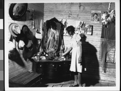 Pre-Teenaged Girl Looking At Various Objects On Dresser In Bedroom At Home by Irving Rusinow Pricing Limited Edition Print image