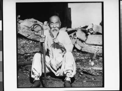 Old Korean Man Sitting In Front Of Destroyed Bldgs. With Cane In Hand by G. Dimitri Boria Pricing Limited Edition Print image