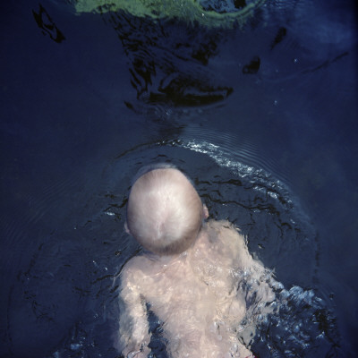 A Boy Swimming In A Lake, Sweden by Mikael Andersson Pricing Limited Edition Print image