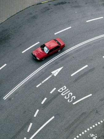 A Red Car Driving On A Multi Lane Street by Anders Lindh Pricing Limited Edition Print image