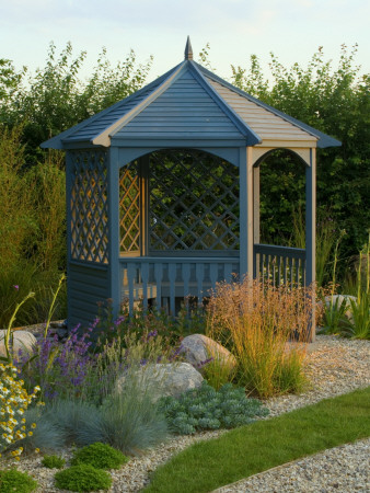 Blue Wooden Summerhouse Beside Lawn With Gravel And Rocks, Designer: Clare Matthews by Clive Nichols Pricing Limited Edition Print image
