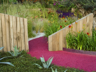 Mediterranean Style Garden With Wooden Walls, Gravel, Hemerocallis And Agaves, Pink Path by Clive Nichols Pricing Limited Edition Print image