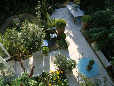 View Onto Small Garden With Italian Hard Limestone Floor And Table by Clive Nichols Pricing Limited Edition Print image