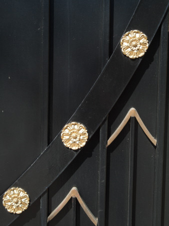 Backgrounds - Detail Of Black Stained Wooden Gate Decorated With Gold Medallions And Chevrons by Natalie Tepper Pricing Limited Edition Print image