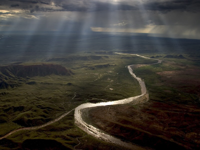 Crepuscular Rays Of Sunlight Shine Over A Snaking River by Randy Olson Pricing Limited Edition Print image