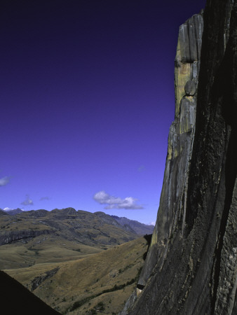 Rock Face Overlooking Mountains Below, Madagascar by Michael Brown Pricing Limited Edition Print image
