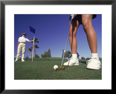 Golfer Putting While Other Person Holds Flag by Preston Lyon Pricing Limited Edition Print image