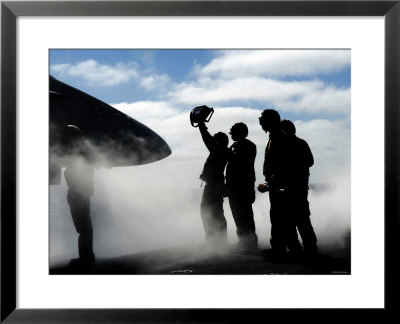 A Flight Deck Crew Member Shows The Pilot Of An F/A-18 Hornet The Aircraft's Weight by Stocktrek Images Pricing Limited Edition Print image