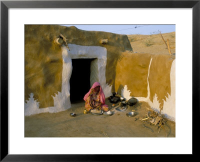 Woman Cooking Outside House With Painted Walls, Village Near Jaisalmer, Rajasthan State, India by Bruno Morandi Pricing Limited Edition Print image