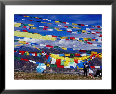 Pilgrim Stringing Up Prayer Flags With Mountains In Background by Krzysztof Dydynski Pricing Limited Edition Print image