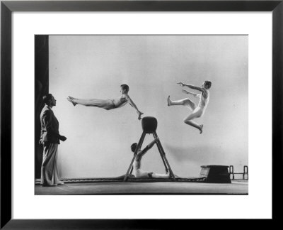 Erik Flensted Jensen, Coach Of Danish Gymnastic Team, Watching As Three Men Perform by Gjon Mili Pricing Limited Edition Print image