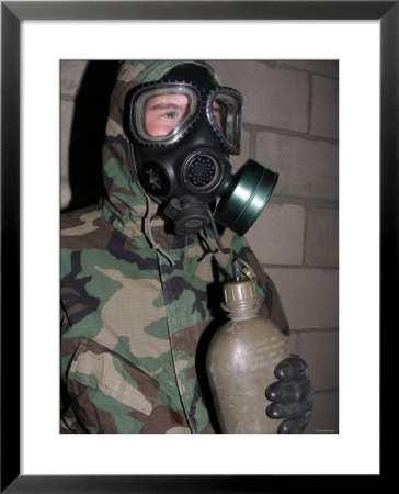 A Marine Drinks Water From His Canteen Through His Gas Mask Inside The Gas Chamber by Stocktrek Images Pricing Limited Edition Print image