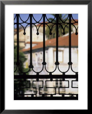 Palms And Red-Roofed Buildings Through Iron Grillwork, Lisbon, Portugal by John & Lisa Merrill Pricing Limited Edition Print image