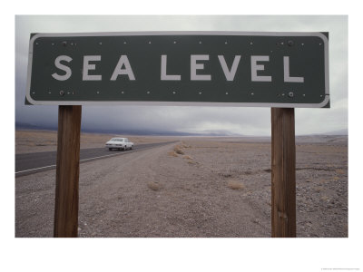 A Sign Declares Sea Level Along A Roadside Near Death Valley by Gordon Wiltsie Pricing Limited Edition Print image