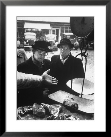 The Butcher Rationing The Amount Of Meat Sold To The Customers Because Of The Postwar Meat Shortage by Cornell Capa Pricing Limited Edition Print image