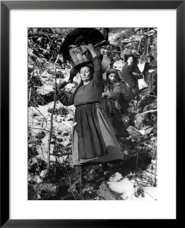 Italian Refugee Women Carrying Their Belongings In Baskets, While Fleeing Their Homes In Wwii by Robert Capa Pricing Limited Edition Print image