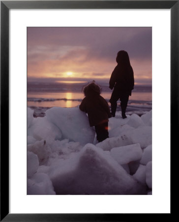 Alaska: Silhoutte Of Native Alaskan Children Watching The Midnight Sun by Ralph Crane Pricing Limited Edition Print image