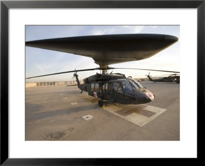 Uh-60 Blackhawk Medivac Helicopter Sits On The Flight Deck At Camp Warhorse by Stocktrek Images Pricing Limited Edition Print image