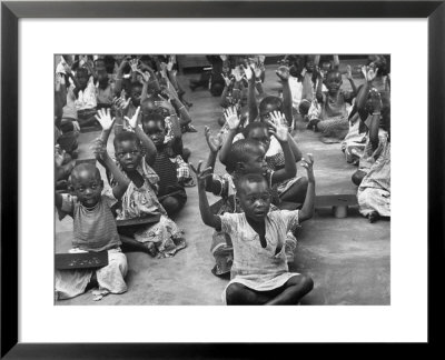 Children Raising Their Hands In The Air During Kipuchi Kindergarten Classes by Dmitri Kessel Pricing Limited Edition Print image