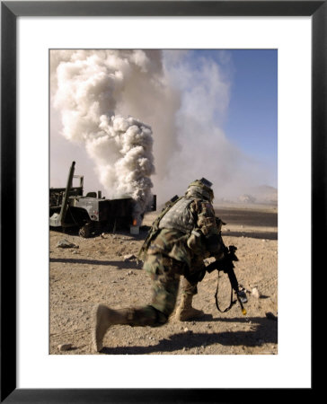 A Us Army Soldier Reacts To A Controlled Explosion by Stocktrek Images Pricing Limited Edition Print image