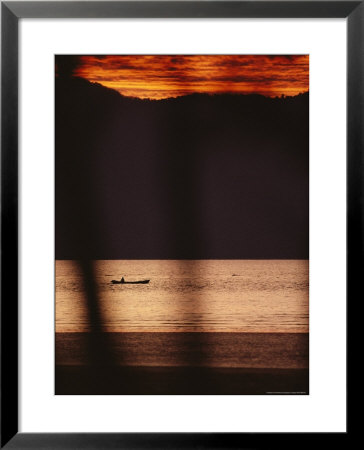 River At Twilight With Boater, Sarawak State, Borneo Island by Mattias Klum Pricing Limited Edition Print image