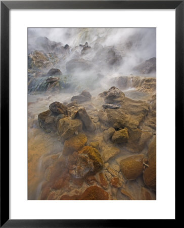 Steaming Water Flows Over Rocks Stained By Algae And Bacteria by Michael Melford Pricing Limited Edition Print image